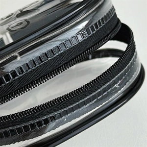Macro detail of waterproof PVC storage bag showing black nylon zipper and fine stitching
