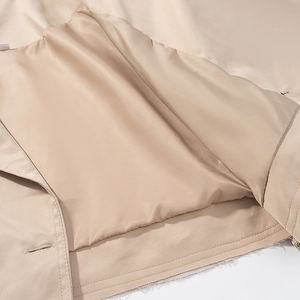 Detailed view of khaki jacket hem showing fine twill fabric and smooth inner lining