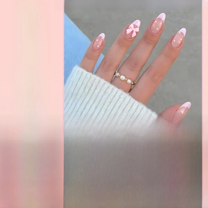 French tip almond press-on nails with 3D pink bows and pearl accents in a set of 24 pieces