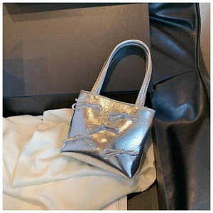 Silver bow-adorned handbag with textured finish presented in a black gift box