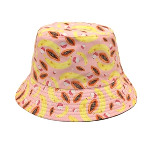 Detailed view of pink bucket hat featuring vibrant banana and papaya fruit patterns