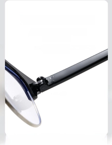 Detailed close-up of a sturdy metal hinge on a black half-rim frame spectacle