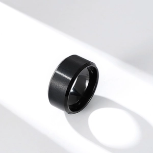 Macro detail of brushed matte black tungsten steel ring showing sleek metallic texture