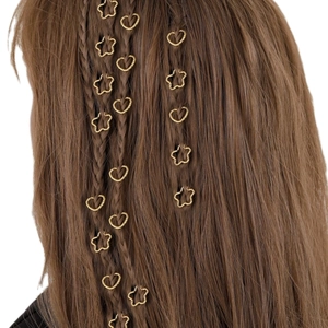 Golden heart and star shaped textured metal hair rings woven into a braided hairstyle