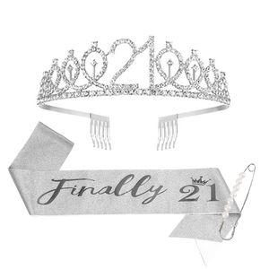 Close-up of 21st birthday kit with silver rhinestone tiara, glitter sash and pearl pin
