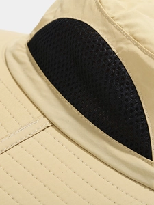 Detail of outdoor sun hat featuring black breathable mesh and reinforced brim stitching