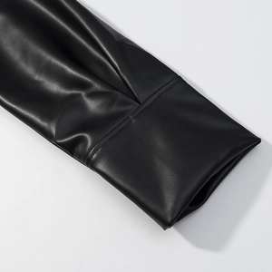 Macro shot of black PU leather sleeve showing fine texture and professional stitching