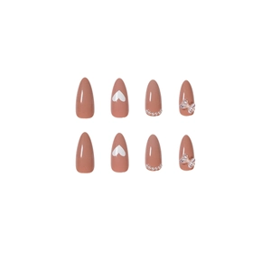 Peach pink almond press-on nails with white heart print, pearls and 3D bows