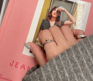 Detail of minimalist S925 sterling silver rings with gold bead accent and wide band