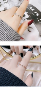 Detail showing hollow chain design rings in silver and rose gold on a model finger