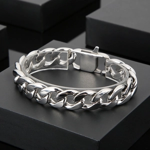 Polished silver cuban link chain bracelet displayed on a premium black gift box set