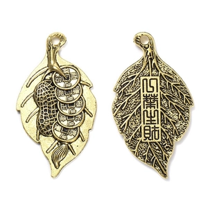 Detailed macro view of antique leaf-shaped copper pendant with traditional Chinese coins