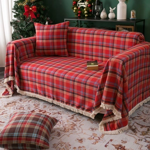 Red plaid sofa cover with cream tassels and matching pillows for Christmas home decor
