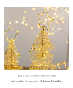 Close-up of golden wire Christmas tree with LED lights and small bells ornament