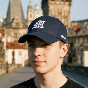 Navy blue baseball cap with white 3D gothic AH embroidery shown in outdoor street style