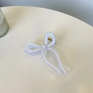Detail view of the elegant dual-layer bow hair claw clip with a strong gold metal spring