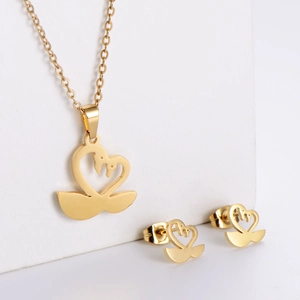 Detail view of a gold-plated swan heart pendant necklace and matching stud earring set
