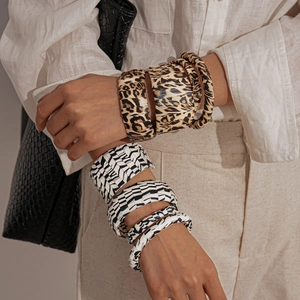 Chic animal print cuff bracelets set featuring leopard and zebra textures on model