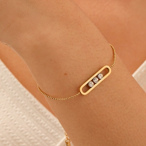 Elegant gold beaded bracelet featuring a signature triple diamond sliding oval charm