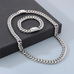 Polished 12mm Cuban link necklace and bracelet set with rectangular clasp on a black gift box