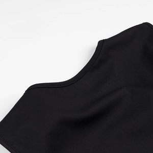 Close-up of black knit top neckline showing premium stitching and fabric texture