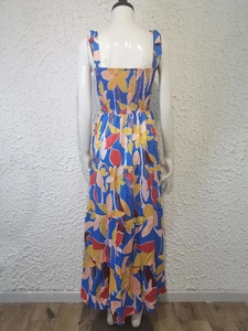 Detail view of floral print maxi dress featuring elastic smocked back and tiered skirt layer