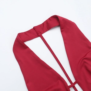 Close-up of red halter neck stitching and smooth synthetic fabric on a jumpsuit