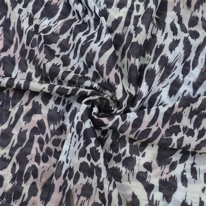 Detailed macro view of breathable leopard print mesh fabric with soft draped texture