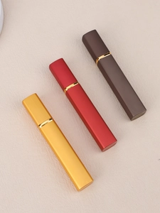 Three 12ml refillable square perfume spray bottles in matte gold, red and brown finishes