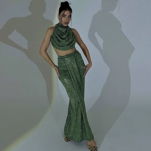 Sparkling green sequin two-piece set featuring halter crop top and high slit maxi skirt