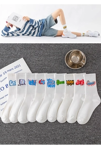 Detailed view of nine white athletic mid-calf socks with vibrant graffiti letter prints