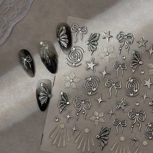 3D silver bow and star embossed nail stickers on textured grey marble background