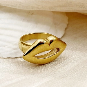 Chic gold-plated titanium steel ring featuring an artistic lip design on a silk background