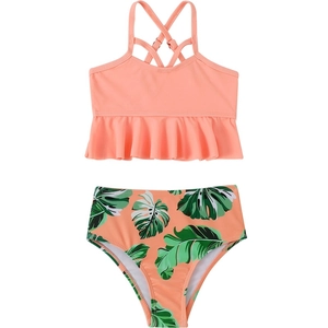 Two-piece girls' swimsuit with peach ruffled top and tropical palm leaf high-waisted bottom