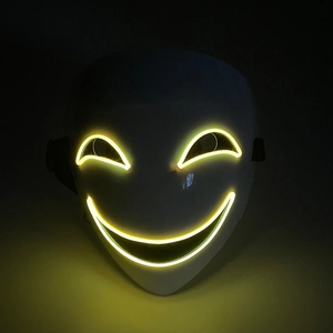 Detail of white clown mask featuring yellow EL wire glowing in dark background