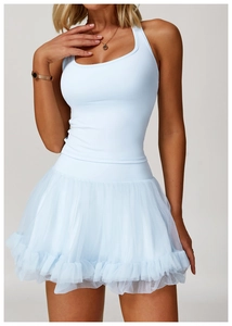 Detail of light blue racerback sports top paired with a layered tulle skirt ensemble