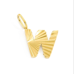 Detailed view of golden stainless steel letter W pendant with sunburst texture
