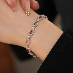 Close-up of elegant multi-color gemstone bracelet with cubic zirconia on female wrist
