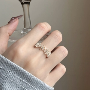 Minimalist silver open ring with hollow flower design worn on finger for fashion look