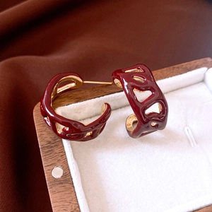 Macro detail of red enamel chain hollow hoop earrings with 18K gold plated finish