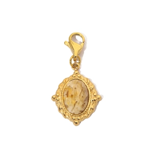Detail of a golden sun pendant with yellow natural stone and stainless steel lobster clasp