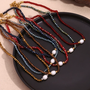 Detailed close-up of colorful crystal bead necklaces with center oval pearl pendants