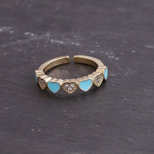 Detail of adjustable gold ring featuring sky blue enamel hearts and pave crystals
