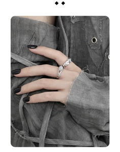Detailed close-up of liquid silver style irregular textured ring worn by a model
