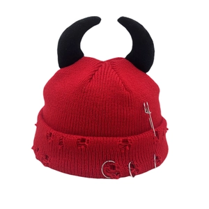 Red knit devil horn beanie with punk pins, distressed details and metal rings