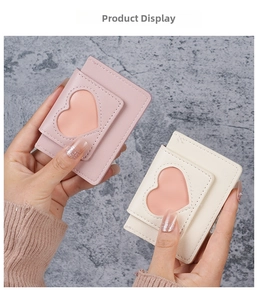 Close-up of minimalist PU leather card holder with heart-shaped window in pink and cream