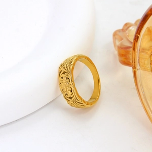 Elegant gold-plated stainless steel ring featuring intricate engraved floral patterns