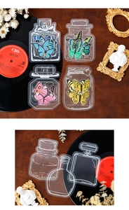 Macro shot of PET butterfly and vintage glass bottle stickers with white ink details