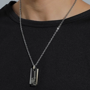 Men's minimalist stainless steel necklace with interlocking double ring pendant on model