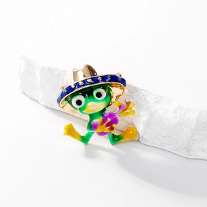 Detailed view of an enamel frog brooch playing a purple guitar with a blue cowboy hat